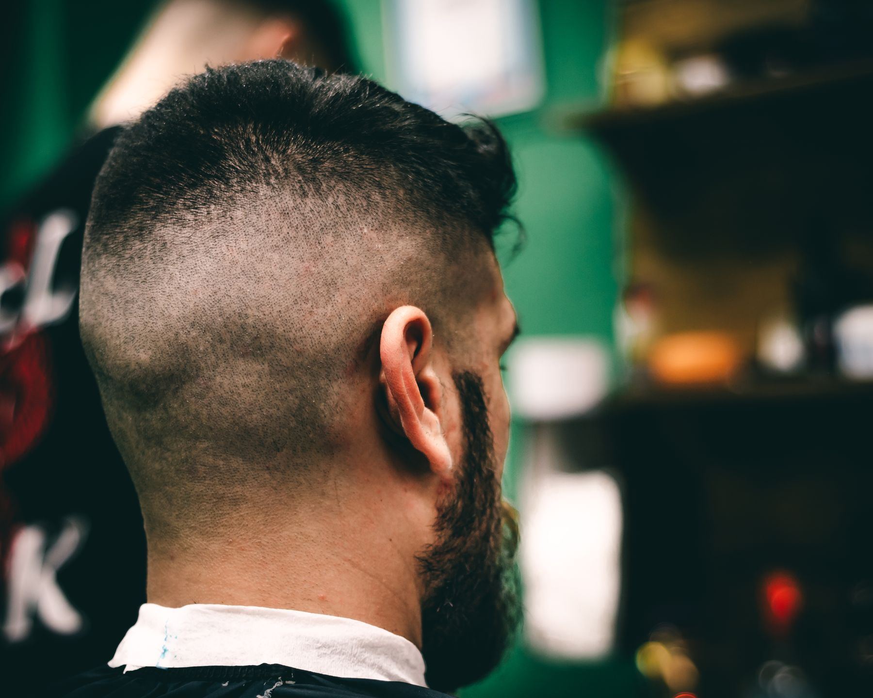 The back of a fresh low fade under warm shop light