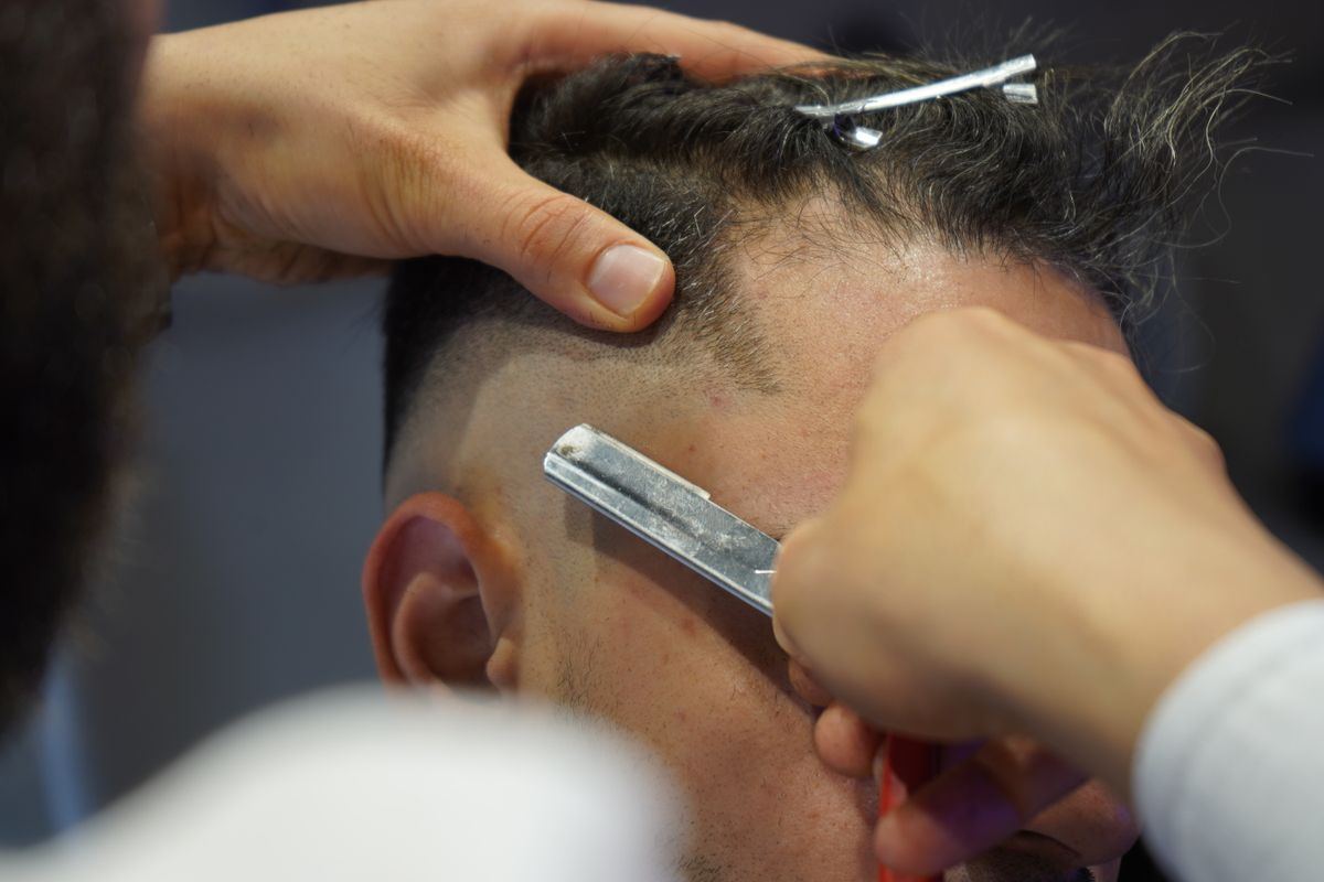 Straight razor cleaning up a neckline over hot lather