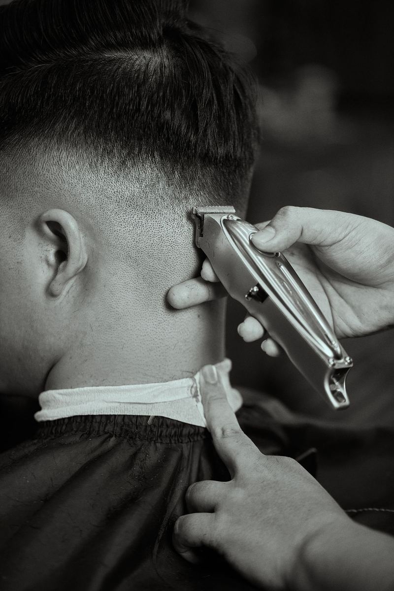 Beard trim in progress in black and white, face turned away from the camera