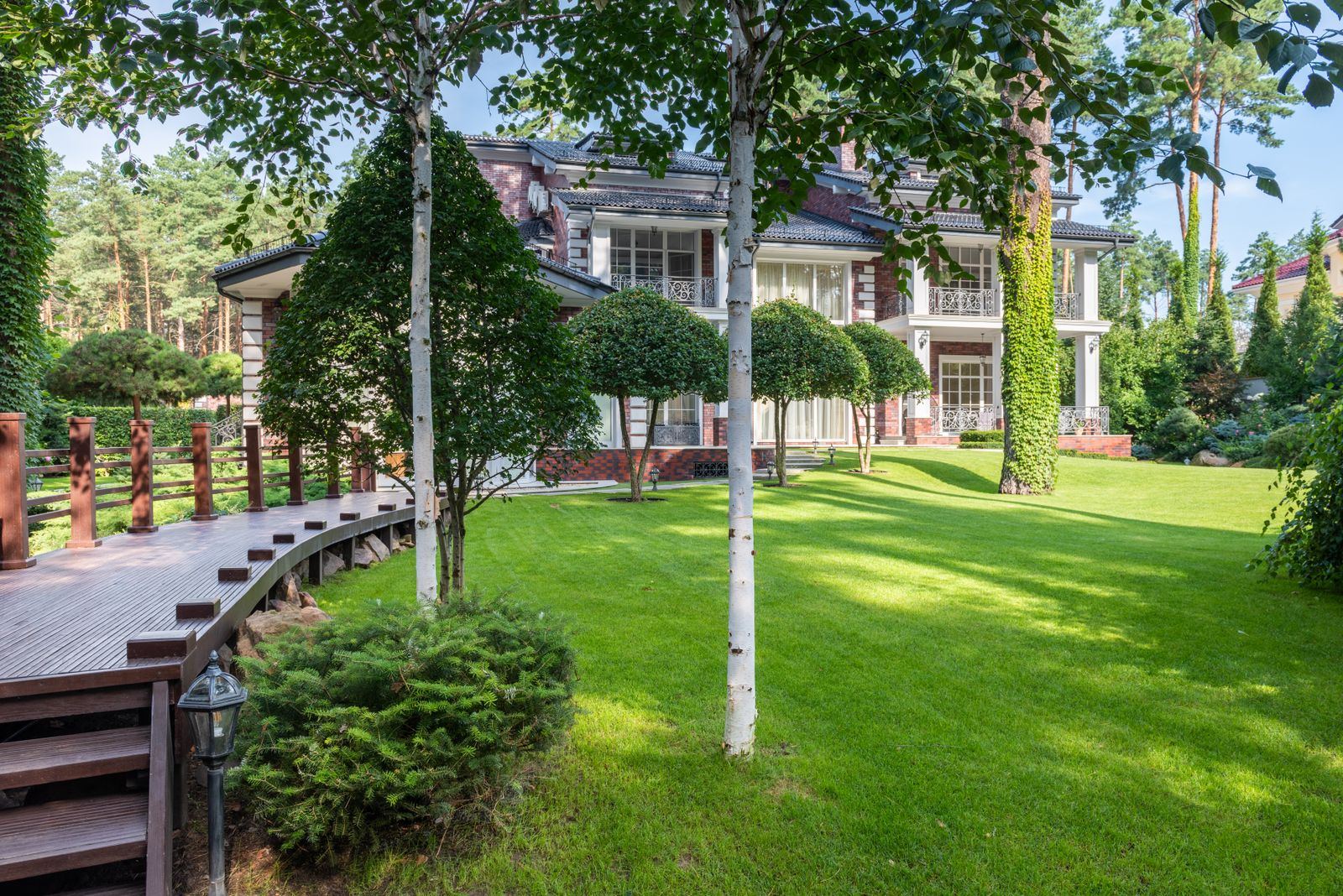 A tidy summer lawn and walkway in front of a house